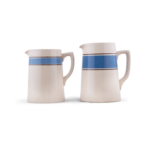 218 - TWO CARRIGALINE POTTERY JUGS, BLUE BAND.   17cm wide