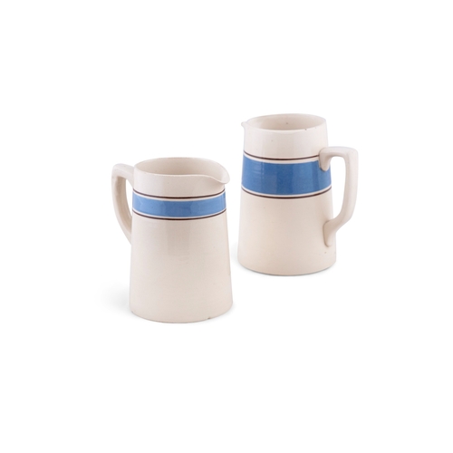 218 - TWO CARRIGALINE POTTERY JUGS, BLUE BAND.   17cm wide