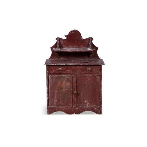 234 - A 19TH CENTURY RED PAINTED TIMBER SCALE MODEL OF AN IRISH CUPBOARD,  the wavy gallery back with shap... 