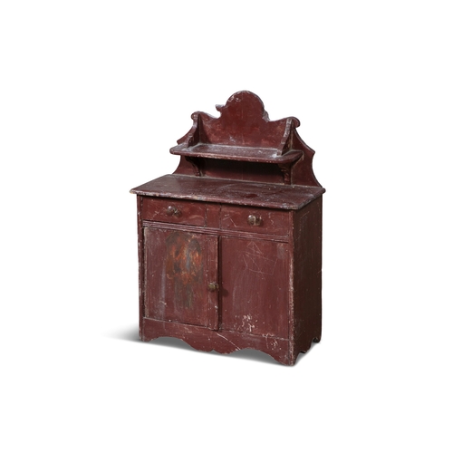 234 - A 19TH CENTURY RED PAINTED TIMBER SCALE MODEL OF AN IRISH CUPBOARD,  the wavy gallery back with shap... 