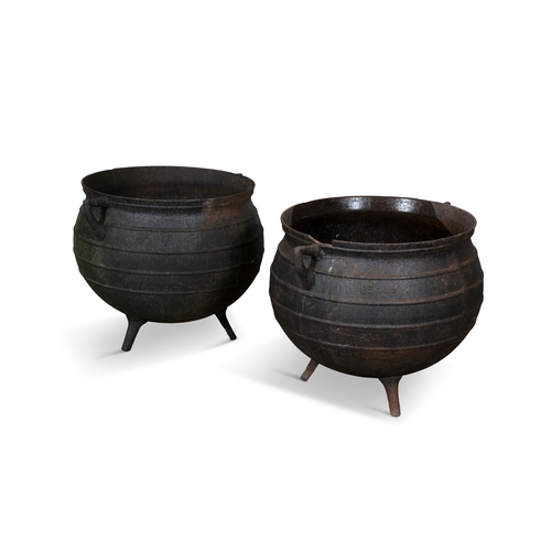 240A - A MATCHED PAIR OF BLACK METAL CALDRONS,  each of circular form with moulded rim, banded body with ra... 