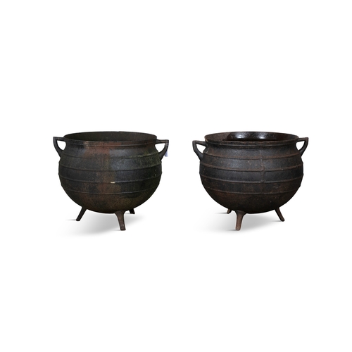 240A - A MATCHED PAIR OF BLACK METAL CALDRONS,  each of circular form with moulded rim, banded body with ra... 