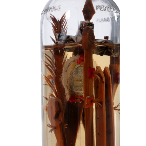 252 - AN UNUSUAL IRISH FOLK ART 'GOD IN A BOTTLE'  with liquid, using an American whiskey bottle. 30cm hig... 