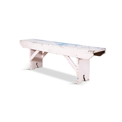 256 - A LONG RECTANGULAR PAINTED PINE LOW STOOL  with plain side supports. 43cm high, 130cm wide