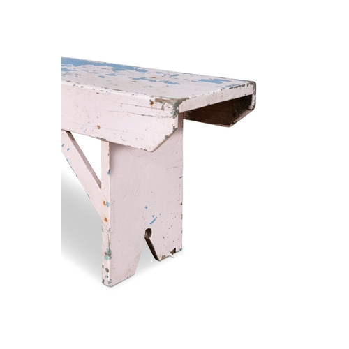 256 - A LONG RECTANGULAR PAINTED PINE LOW STOOL  with plain side supports. 43cm high, 130cm wide