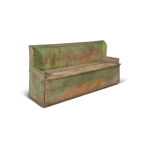 29 - A 19TH CENTURY VARIEGATED GREEN PAINTED PINE SETTLE BED,  the slatted back above a plain seat, hinge... 