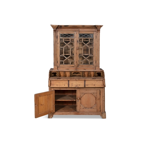 49 - A PINE BUREAU BOOKCASE,  the plain frieze top above twin glazed cupboard doors each with inset led a... 