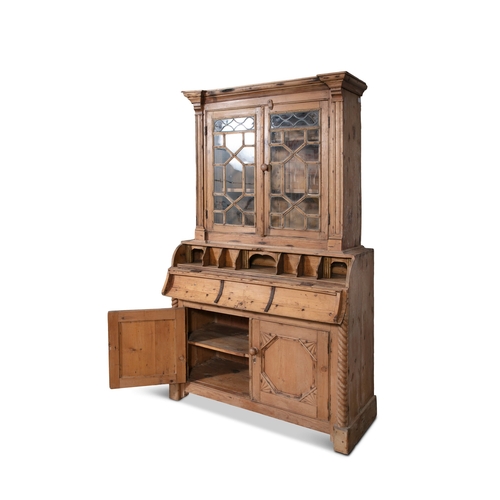 49 - A PINE BUREAU BOOKCASE,  the plain frieze top above twin glazed cupboard doors each with inset led a... 