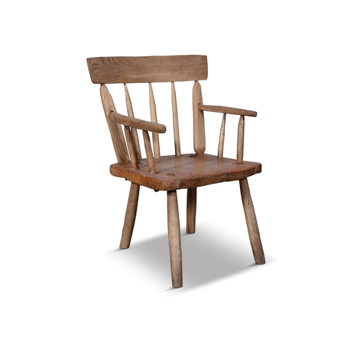 72 - A STAINED TIMBER HEDGE CHAIR  with carved rail backs, and spindle supports, plain armrest and canted... 