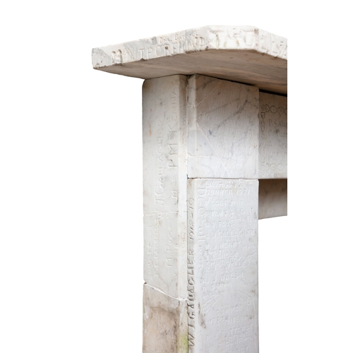 73 - A WHITE MARBLE FIREPLACE  186 cm high, 131cm wide     This carved and antique graffitied fireplace s... 