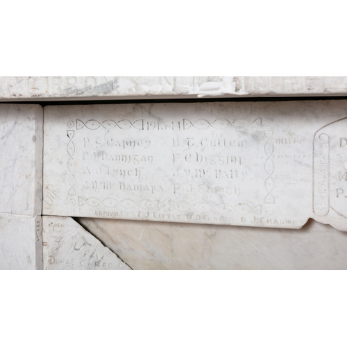 73 - A WHITE MARBLE FIREPLACE  186 cm high, 131cm wide     This carved and antique graffitied fireplace s... 