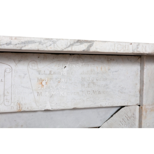 73 - A WHITE MARBLE FIREPLACE  186 cm high, 131cm wide     This carved and antique graffitied fireplace s... 