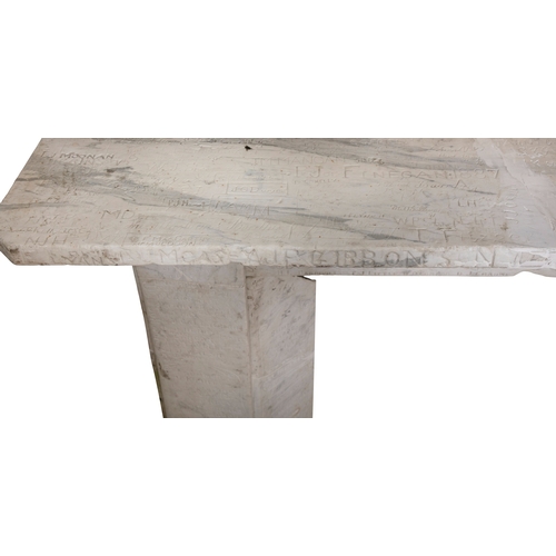 73 - A WHITE MARBLE FIREPLACE  186 cm high, 131cm wide     This carved and antique graffitied fireplace s... 