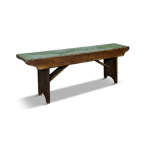 90 - A 19TH CENTURY STAINED AND PAINTED LONG BENCH,  with green painted seat above a shaped frieze with t... 