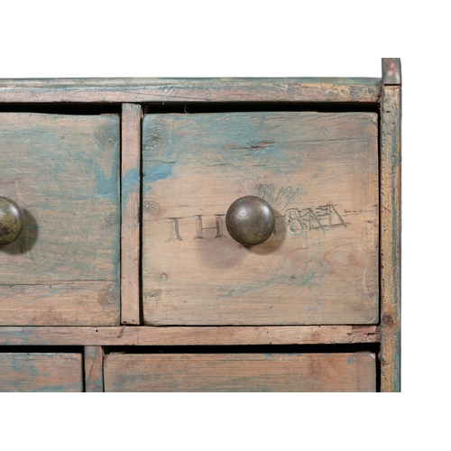 92 - A VARIEGATED BLUE PAINTED PINE GERNERAL MERCHANT'S BANK OF TWENTY-SIX DRAWERS,  the low gallery top ... 