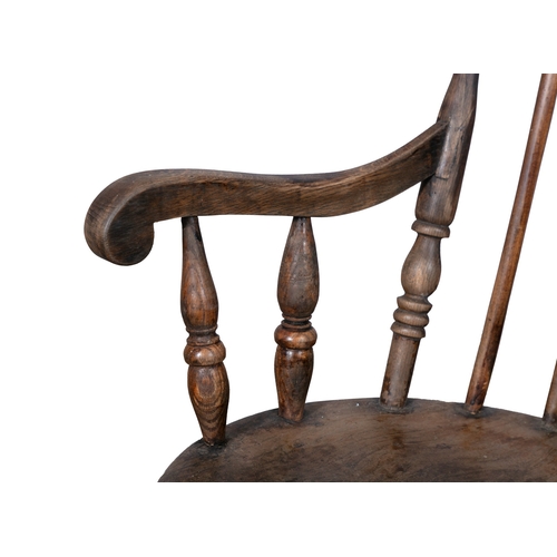 96 - A TRADITIONAL PATTERN WINDSOR STYLE CHAIR  with carved spindle back and circular panel seat on cante... 