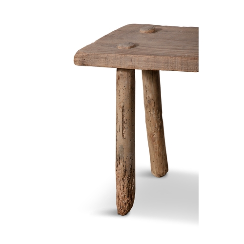 99 - A PLAIN MILKING STOOL  with four spindle supports. 34cm high, 40cm wide  Provenance: Mountrath, Co. ... 