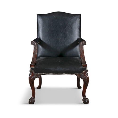 47 - A GEORGE III 'GAINSBOROUGH'  LIBRARY ARMCHAIR,  upholstered in black leather, with out scrolling lea... 