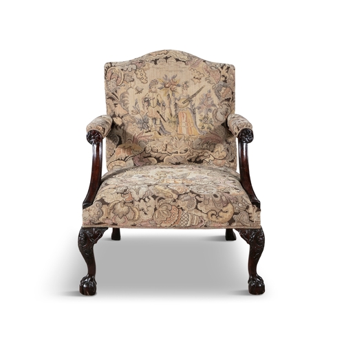 55 - A GEORGE III MAHOGANY FRAMED GAINSBOROUGH ARMCHAIR   the arched padded back and seat covered in a ta... 