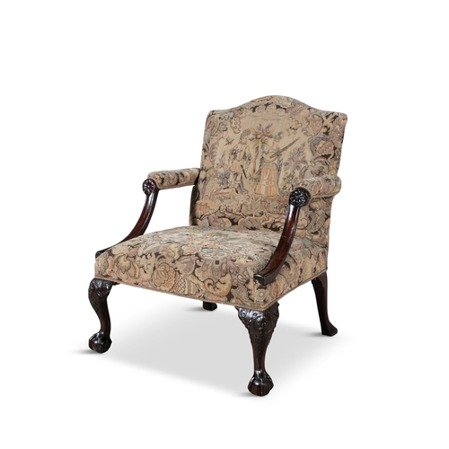 55 - A GEORGE III MAHOGANY FRAMED GAINSBOROUGH ARMCHAIR   the arched padded back and seat covered in a ta... 