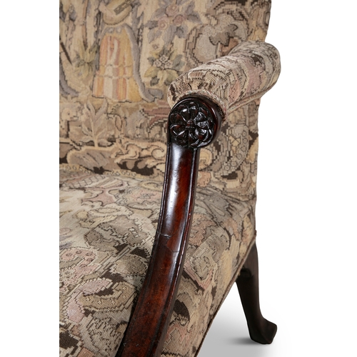 55 - A GEORGE III MAHOGANY FRAMED GAINSBOROUGH ARMCHAIR   the arched padded back and seat covered in a ta... 