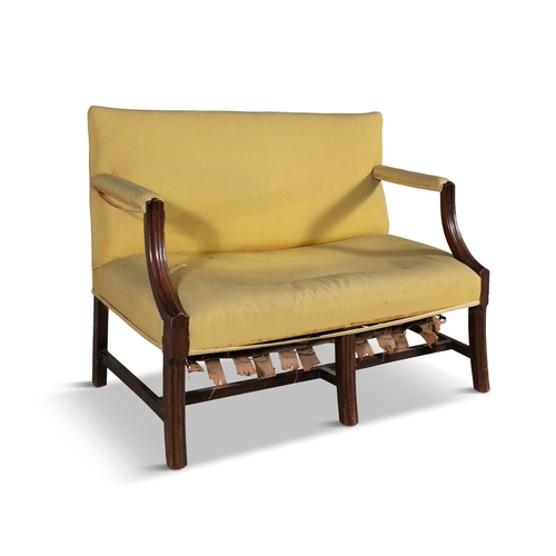 60 - A GEORGE III MAHOGANY FRAMED TWO-SEATER SETTEE, C.1800  with reeded arm supports and tapering inswep... 