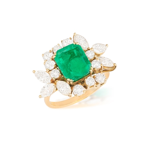 114 - AN EMERALD AND DIAMOND DRESS RING  The rectangular cut-cornered emerald weighing approximately 3.50c... 