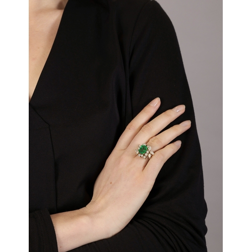 114 - AN EMERALD AND DIAMOND DRESS RING  The rectangular cut-cornered emerald weighing approximately 3.50c... 