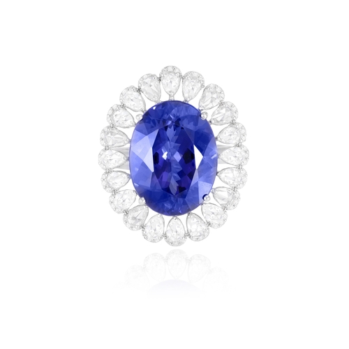 120 - A FINE TANZANITE AND DIAMOND DRESS RING  The oval-shaped tanzanite weighing approximately 16.00cts, ... 