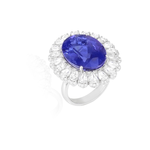 120 - A FINE TANZANITE AND DIAMOND DRESS RING  The oval-shaped tanzanite weighing approximately 16.00cts, ... 