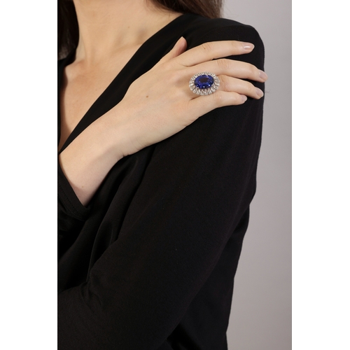 120 - A FINE TANZANITE AND DIAMOND DRESS RING  The oval-shaped tanzanite weighing approximately 16.00cts, ... 