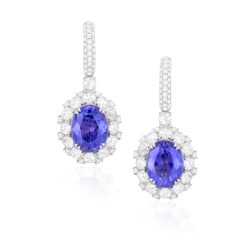 121 - A PAIR OF TANZANITE AND DIAMOND PENDENT EARRINGS  Each oval-shaped tanzanite weighing approximately ... 