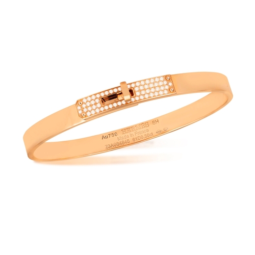 122 - AN 18K GOLD AND DIAMOND 'KELLY BRACELET' BY HERMÈS  The polished oval gold bangle with 'Kelly' turn-... 