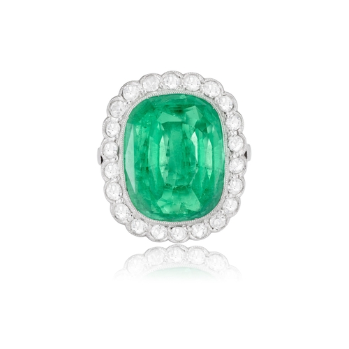 140 - AN EMERALD AND DIAMOND CLUSTER RING  The cushion-shaped emerald weighing approximately 6.50cts withi... 