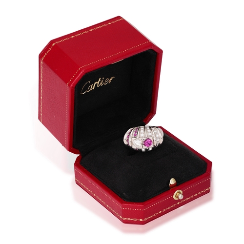 147 - A RUBY AND DIAMOND DRESS RING, CARTIER  Of domed fluted design, set with a brilliant-cut diamond and... 