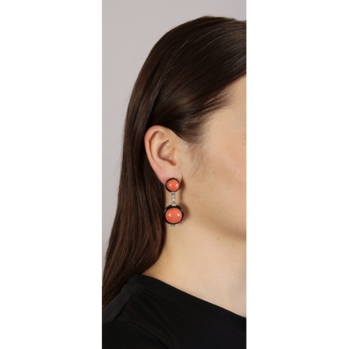 170 - A PAIR OF CORAL, ONYX AND DIAMOND PENDENT EARRINGS  Each circular-shaped coral cabochon within an on... 