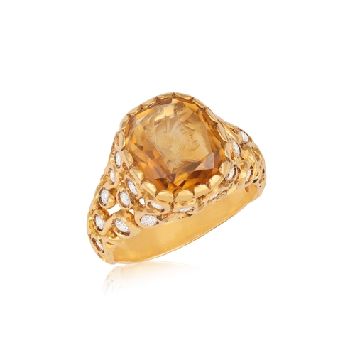 177 - A DIAMOND AND CITRINE INTAGLIO RING  The openwork scrolled raised mount, set with brilliant-cut diam... 