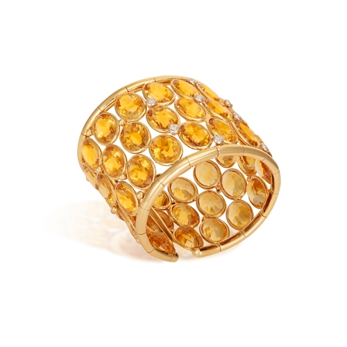 178 - A CITRINE AND DIAMOND CUFF-BRACELET  Of wide openwork design, set with oval-shaped citrines within c... 