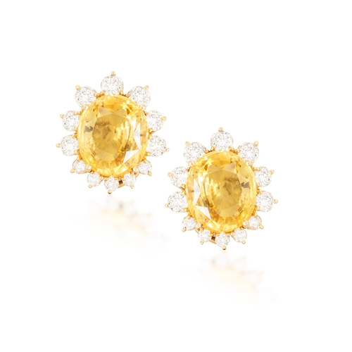 180 - A PAIR OF SAPPHIRE AND DIAMOND PENDENT EARRINGS  Each surmount set with an oval-shaped yellow sapphi... 