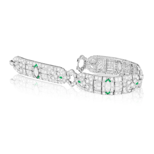 29 - A DIAMOND BRACELET  Composed of openwork motifs of geometric and foliate design, the central one cen... 