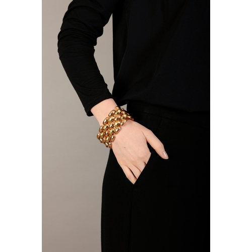 35 - A GOLD RETRO COCKTAIL BRACELET, CIRCA 1940  Of bi-coloured design, the large articulated bracelet co... 