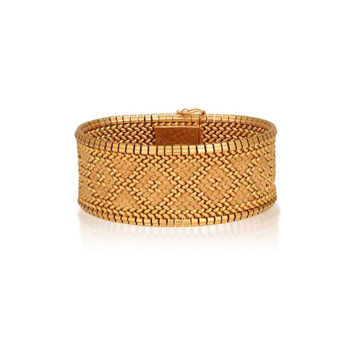 56 - A GOLD BRACELET, FRENCH, CIRCA 1965  The textured and polished strap designed to resemble embroidery... 