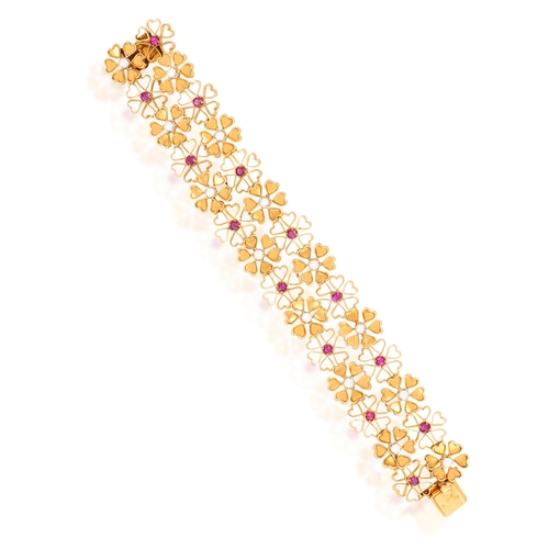 58 - A RUBY AND DIAMOND BRACELET, BY PÉRY & FILS  Of openwork design, composed of flowerheads throughout,... 