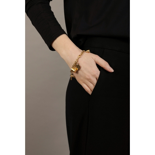 98 - A GOLD AND DIAMOND CHARM BRACELET, BY TIFFANY & CO.  The cable-link chain suspending six gold charms... 