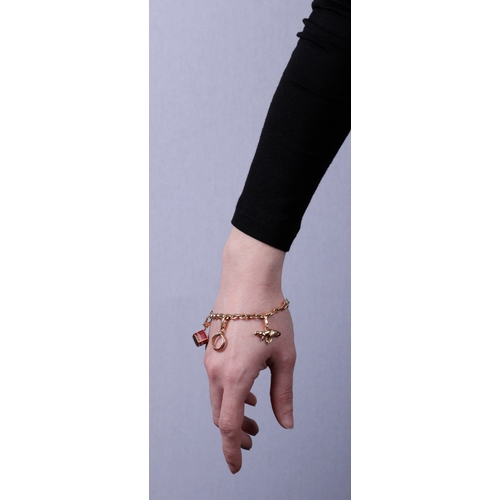 99 - A GOLD CHARM BRACELET, BY CARTIER  The belcher-link chain bracelet, suspending five detachable charm... 