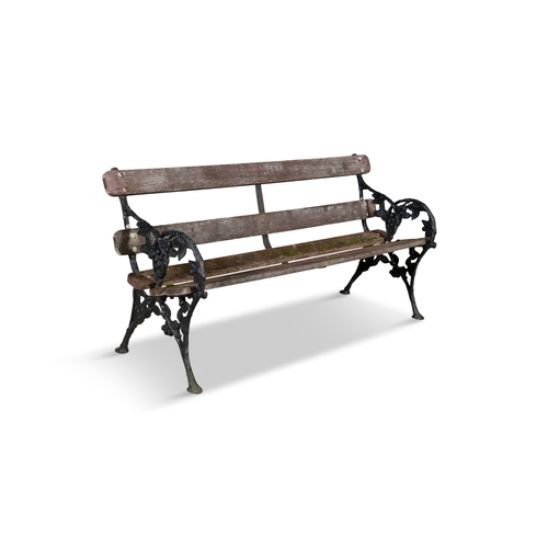 13 - A BLACK PAINTED CAST IRON GARDEN BENCH,   with foliate end supports and timber back and seat. 158cm ... 