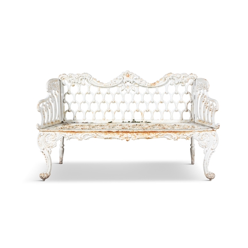 14 - A VICTORIAN WHITE PAINTED CAST IRON GARDEN BENCH   the arched foliate top rail above openwork back, ... 