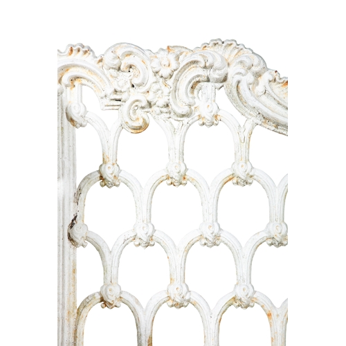 14 - A VICTORIAN WHITE PAINTED CAST IRON GARDEN BENCH   the arched foliate top rail above openwork back, ... 