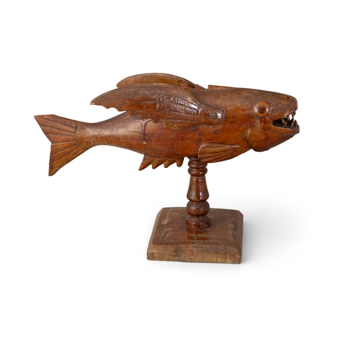 23 - FRED CHRISTIAN Sculpture of a flying fish Wood, on turned column support and square base, 21cm high ... 