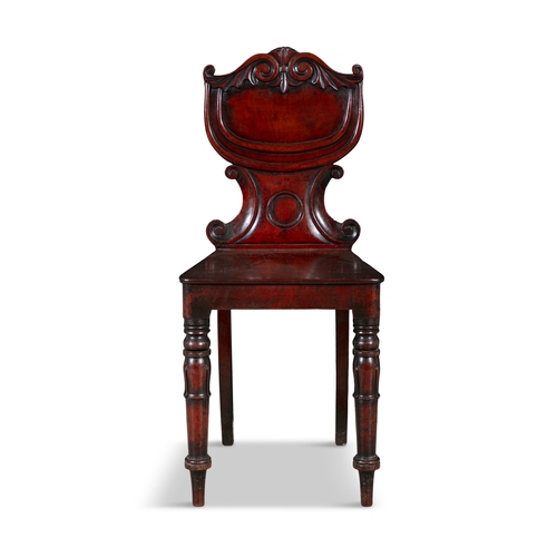 25 - A VICTORIAN MAHOGANY HALL CHAIR,  with scroll framed shield shaped back, over panelled seat, on turn... 